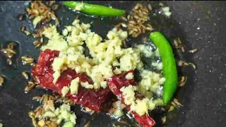 Frying cumin seeds, red chilly and green chili for shalgam ki sabzi