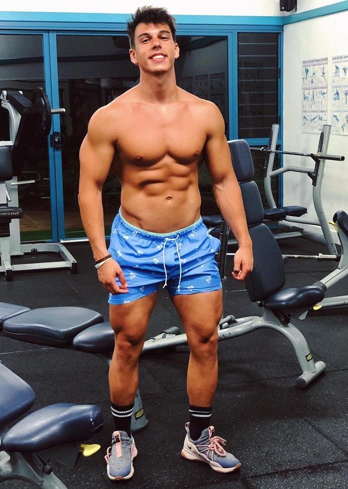 cute-shirtless-fit-beefy-teen-college-jock-smiles-gym-bro-blue-shorts-naughty-dude