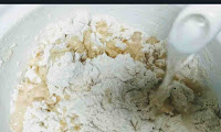 Kneading wheat flour with water for Gobi paratha recipe