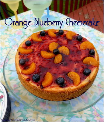 Orange Blueberry Cheesecake, bursting with orange flavor and studded with fresh blueberries. | Recipe developed by www.BakingInATornado.com | #recipe #dessert