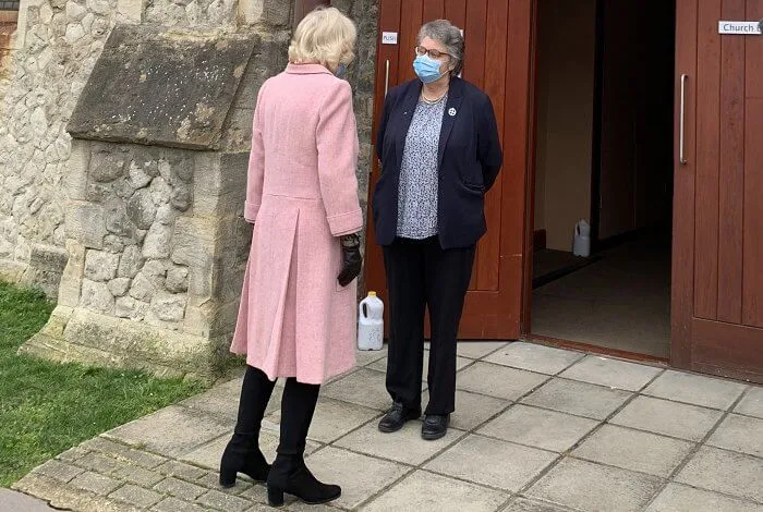 The Duchess met with those involved in the vaccination process, including NHS staff, volunteers and representatives. Pink wool coat and black boot