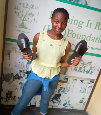 Favour holding Sandals
