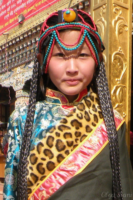 Tibetan girl wearing turquoise coral and amber head ornament 