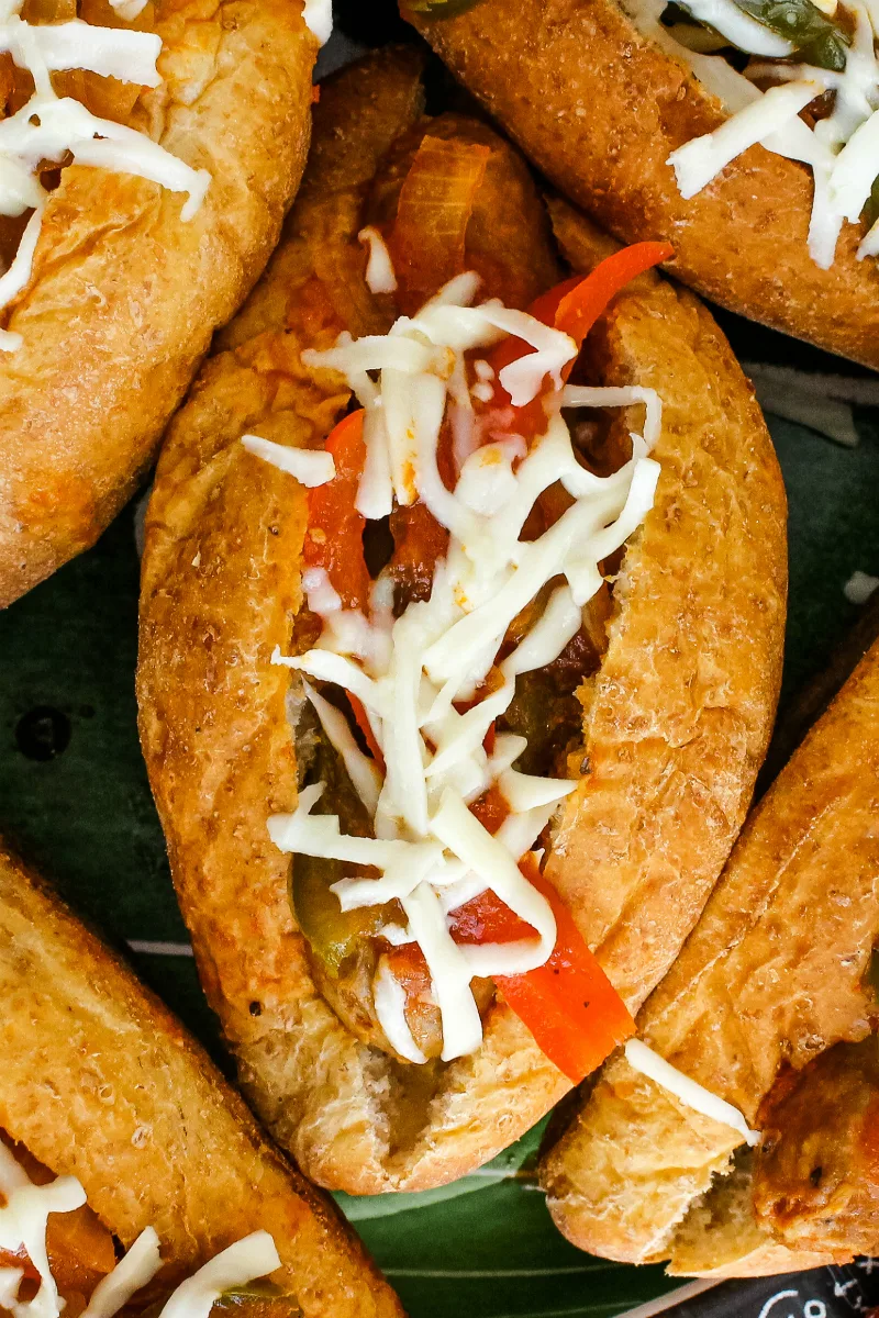 Slow Cooker Sausage, Pepper, and Onion Sandwiches are easily made with just six ingredients! Marinara sauce mingles with Italian sausages and fresh veggies in your slow cooker to make a sandwich that you will want to make again and again. #sausagesandwiches #slowcooker 