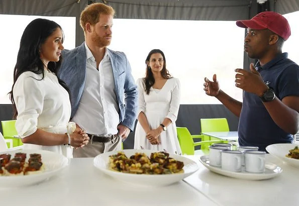 Meghan Markle wore a white belted shirt dress, and Madewell stone and tassel earrings, Stuart Weitzman suede pumps