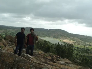Hikers stand on a hillock, overseeing over 200 lakes and ponds at the Melukote