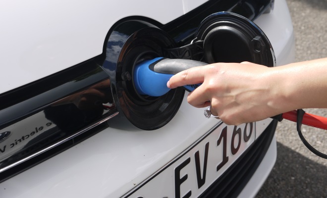 Plugging in to charge an electric car