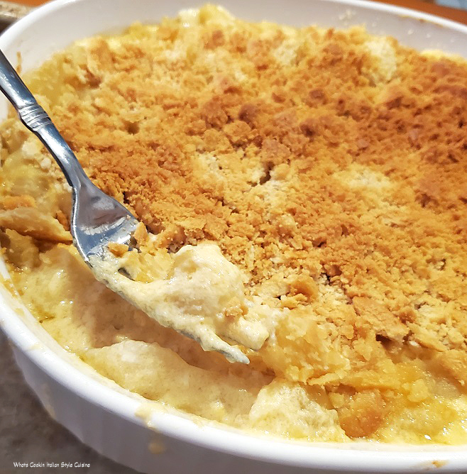 this is a baked casserole in a white dish with Italian macaroni and cheese