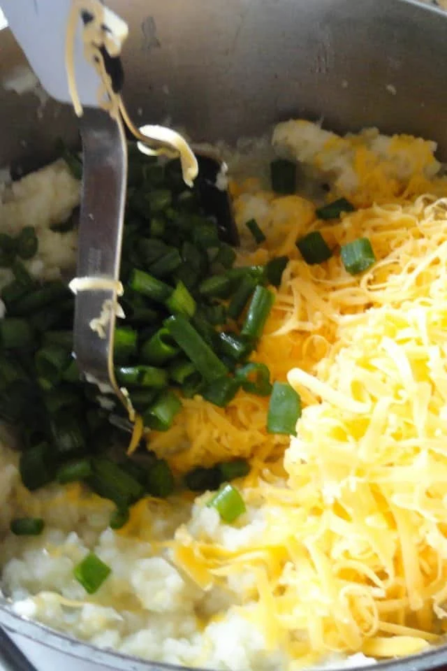 Mashed Cauliflower with Chopped Green Onion and Shredded Cheddar Cheese.