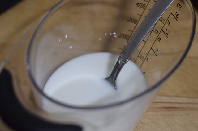 Cornstarch and water mixed together in a measuring cup to make a slurry. 