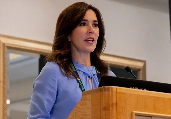 Crown Princess Mary wore a flare-sleeve knot blouse by Victoria Beckham. The Princess wore a navy lace midi dress