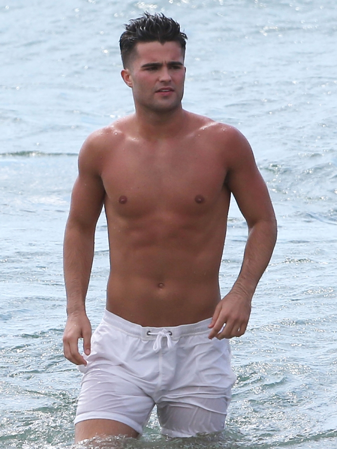 Spencer boldman hits the surf in cute white shorts.