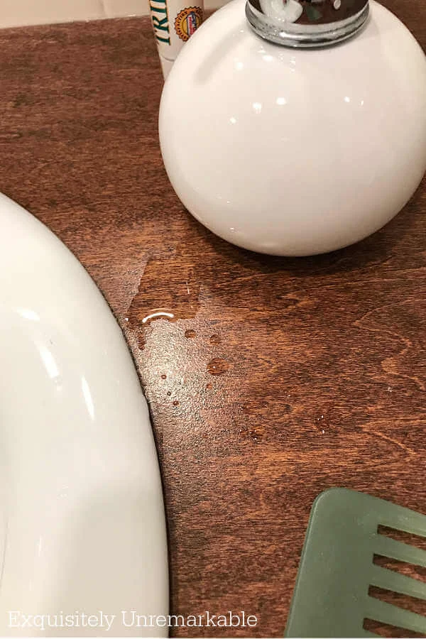 Water puddle on wooden countertop in the bathroom