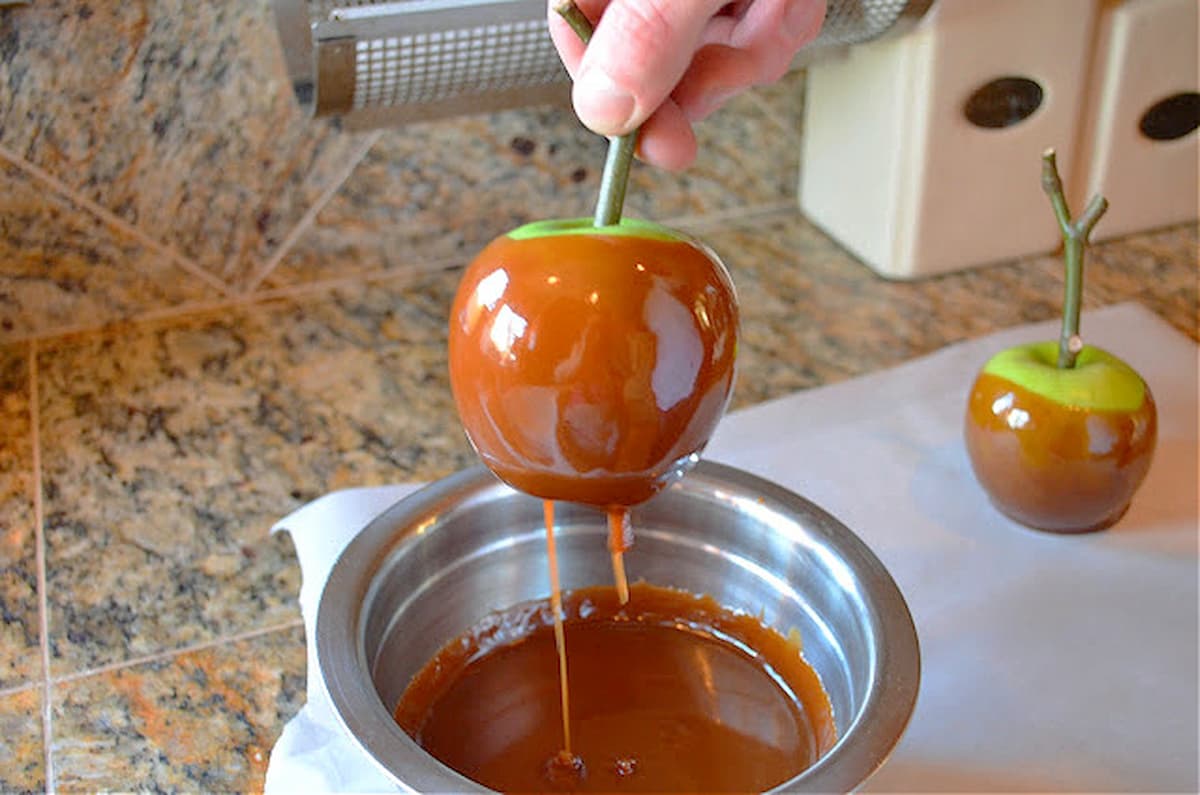 A Homemade Caramel Apple with Caramel dripping off.