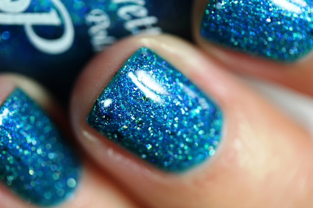 Tropical blue nail polish with holo flakes and multicolored flakes