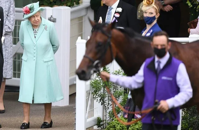 Queen Elizabeth wore an aquamarine coloured coat and dress and a matching hat adorned with pink flowers. Palm Leaf brooch