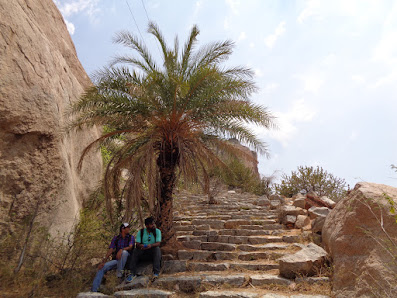 Hikers rest at a stop, taking a break from the heat during the pavagada trek
