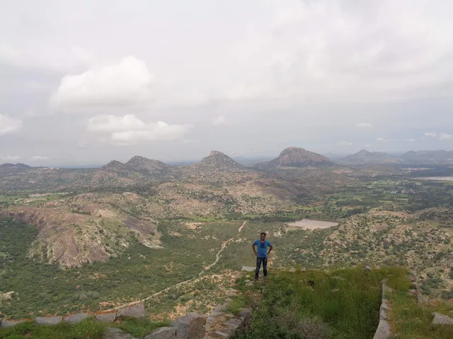 Ashok standing on the summit of Channarayanadurga with Madhugiri seen in the background