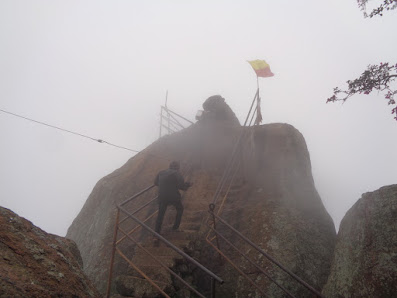 Ashok bravely climbing towards the nandi statue on the slippery steps on a foggy day at shivagange