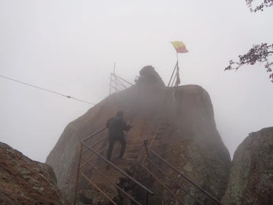 Ashok bravely climbing towards the nandi statue on the slippery steps on a foggy day at shivagange