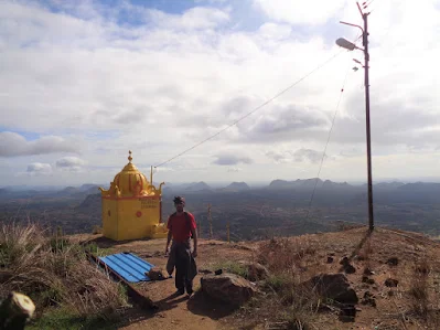 Hiker standing proudly on the summit of kabbaladurga