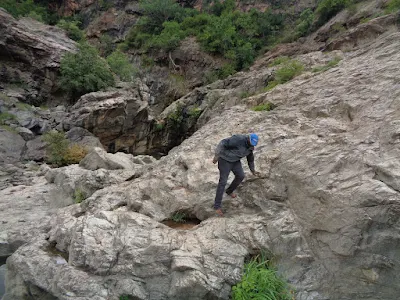 Chinmay carefully getting down the rock face at Ganalu falls