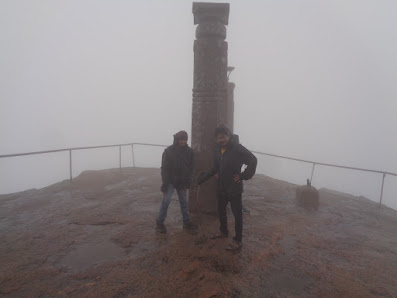 Hikers struggle to stand up straight as the wind speeds were high on the summit of shivange