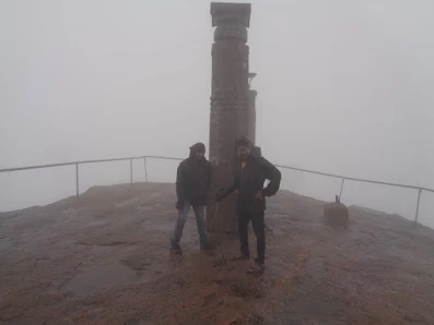 Hikers struggle to stand up straight as the wind speeds were high on the summit of shivange