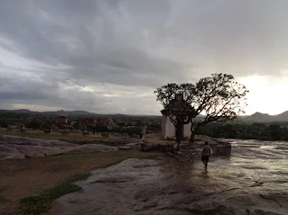 Madhu enjoying the evening rain showers with the Virupaksha temple in the background