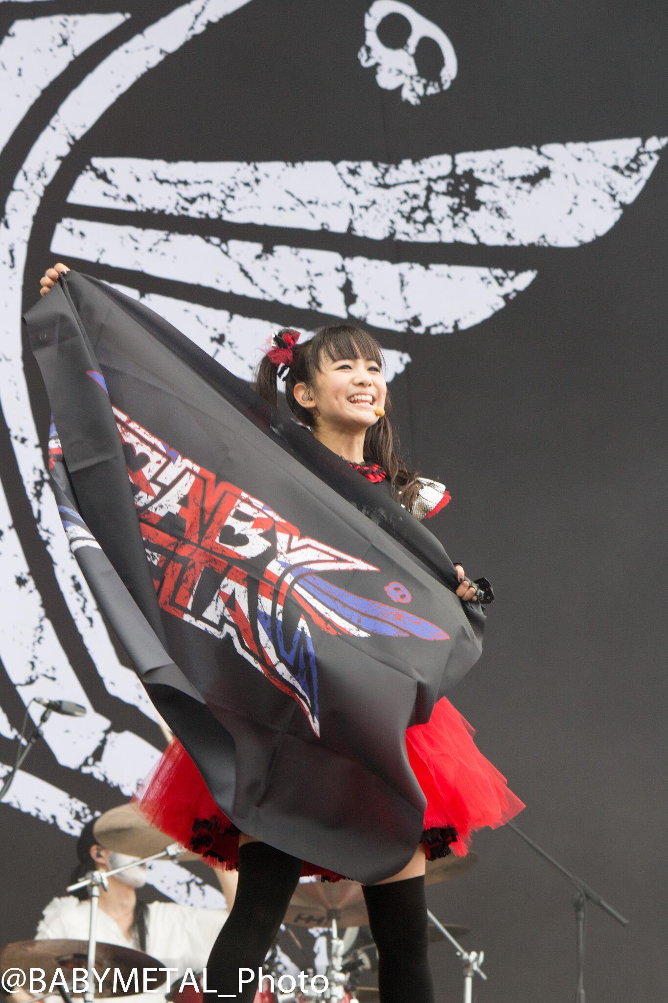 MOAMETAL holding a UK flag at a festival