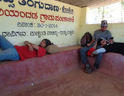 the loapers chilling at a bus stop in virajpete, we sleep where we feel comfortable