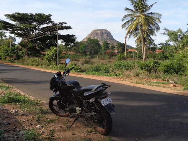 Sippy's bike resting just before entering the town of Kabbalu with kabbaladurga in the background