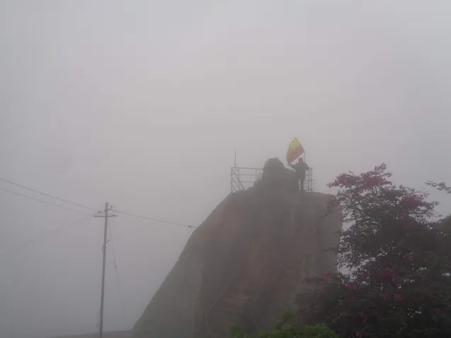hiker at the summit of shivagange on a very foggy day