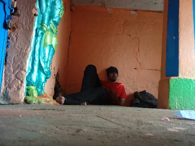As it was a solo trek, hiker peacefully rests in the shiva temple on the summit