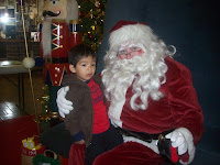 Toddler boy sitting on Santa Clause's lap