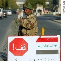 An Iraqi soldier controls traffic at a checkpoint in central Baghdad.