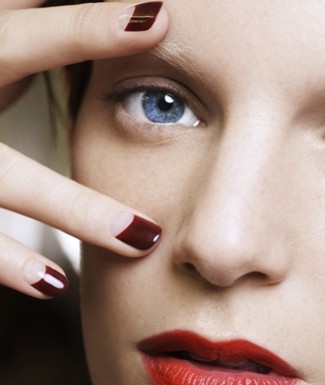Why not put a spin on the classic color by creating the halfmoon manicure