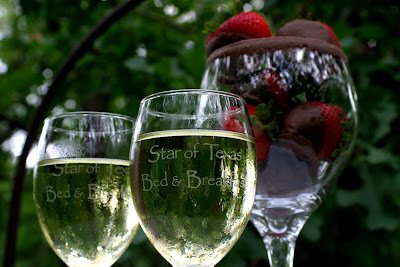 wine glasses full of wine and chocolate strawberries