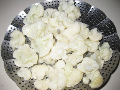 cauliflower in a steamer basket