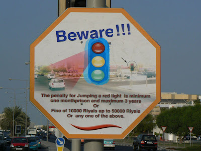 Qatari Road Sign: warning against jumping red lights