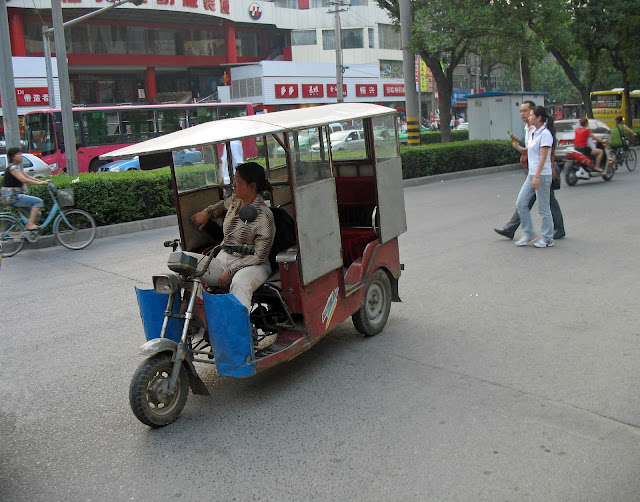 woman rickshaw driver in China