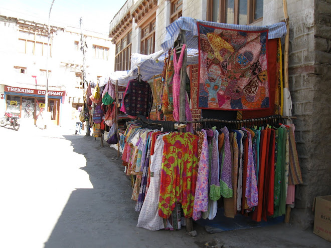 Colourful clothes and rugs for sale