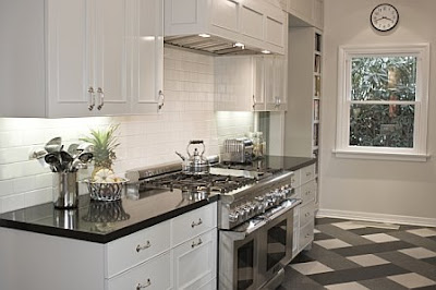 Crisp white kitchen glass-front cabinets and shiny black granite