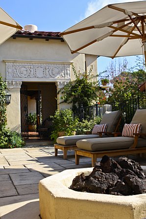 Auto court entry is turned into a poolside lounge space with a fire pit after remodeling
