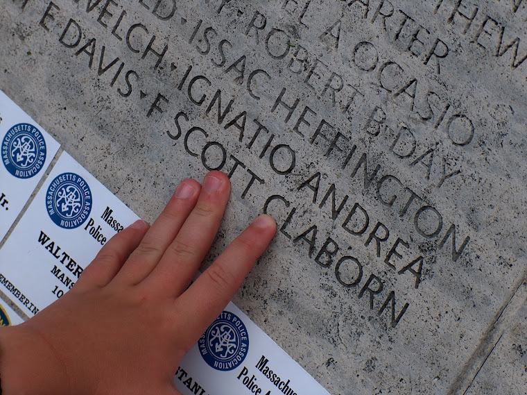 Tanner touching his daddy's name on the memorial wall in Washington D.C.