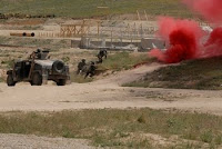 Afghan National Army commandos of the 6th Kandak react to a simulated bomb blast and follow-on firefight during a demonstration of combat techniques and procedures held in conjunction with the first ANA Corps and Commando Commanders’ Conference...
