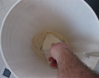 Filling the paint strainer up with the 
rice-Sake mixture from the fermenter.