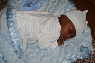 Infant baby boy sleeping on a blue blanket