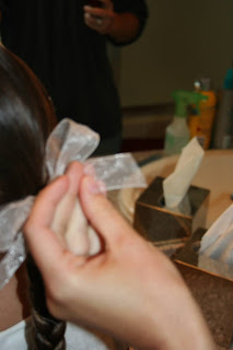 Hand holding a white ribbon