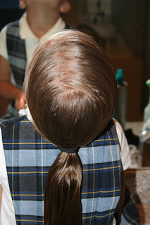 Young girl's hair being styled in to "Ponytail Of Twists" hairstyle